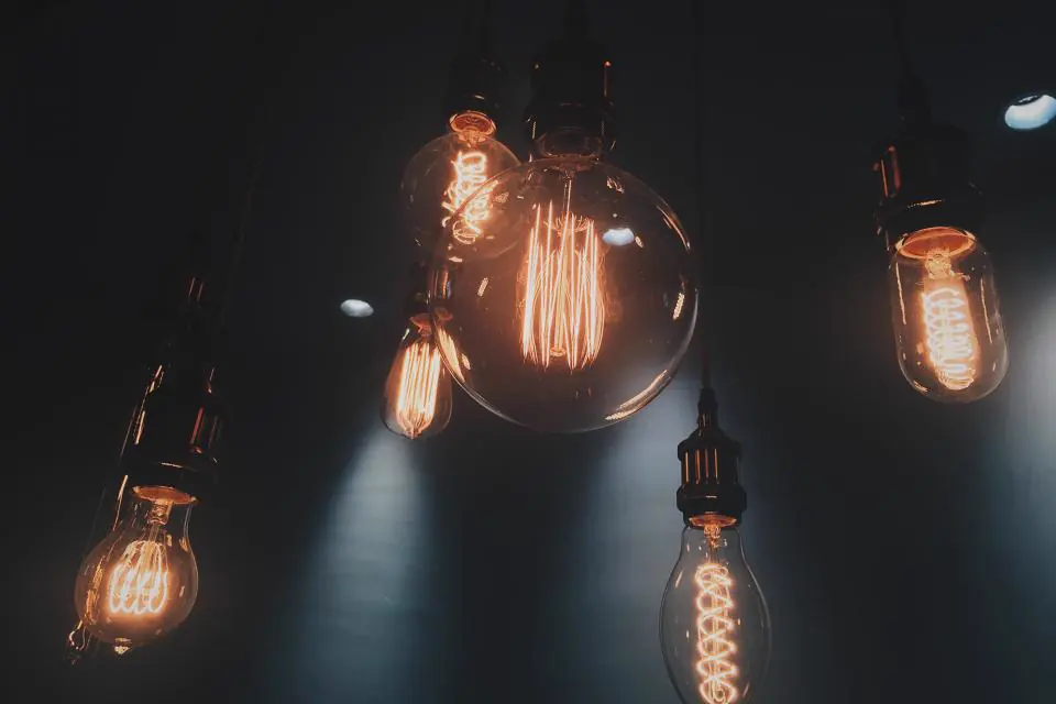 Filament light bulbs hanging against a dark wall