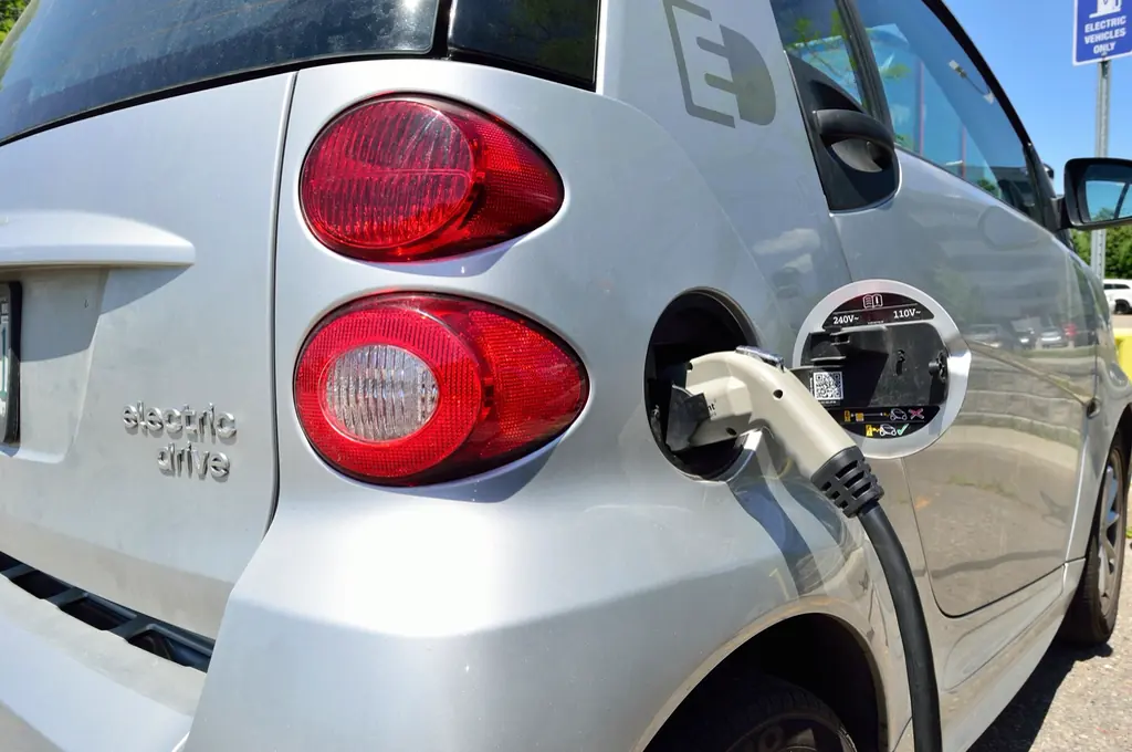 Charging cable plugged into the side of an electric car