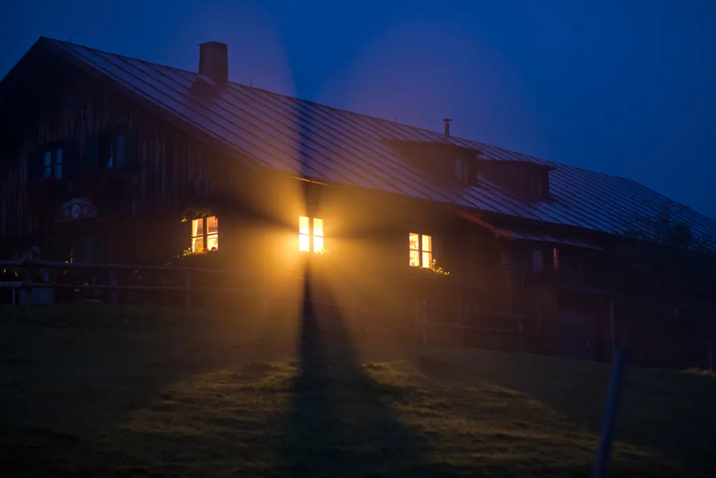 House at dusk with warm light in the windows
